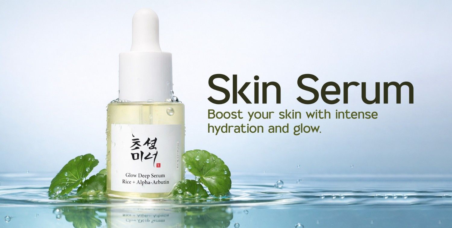Clear glass dropper bottle of Skin Serum with green leaves and water droplets.