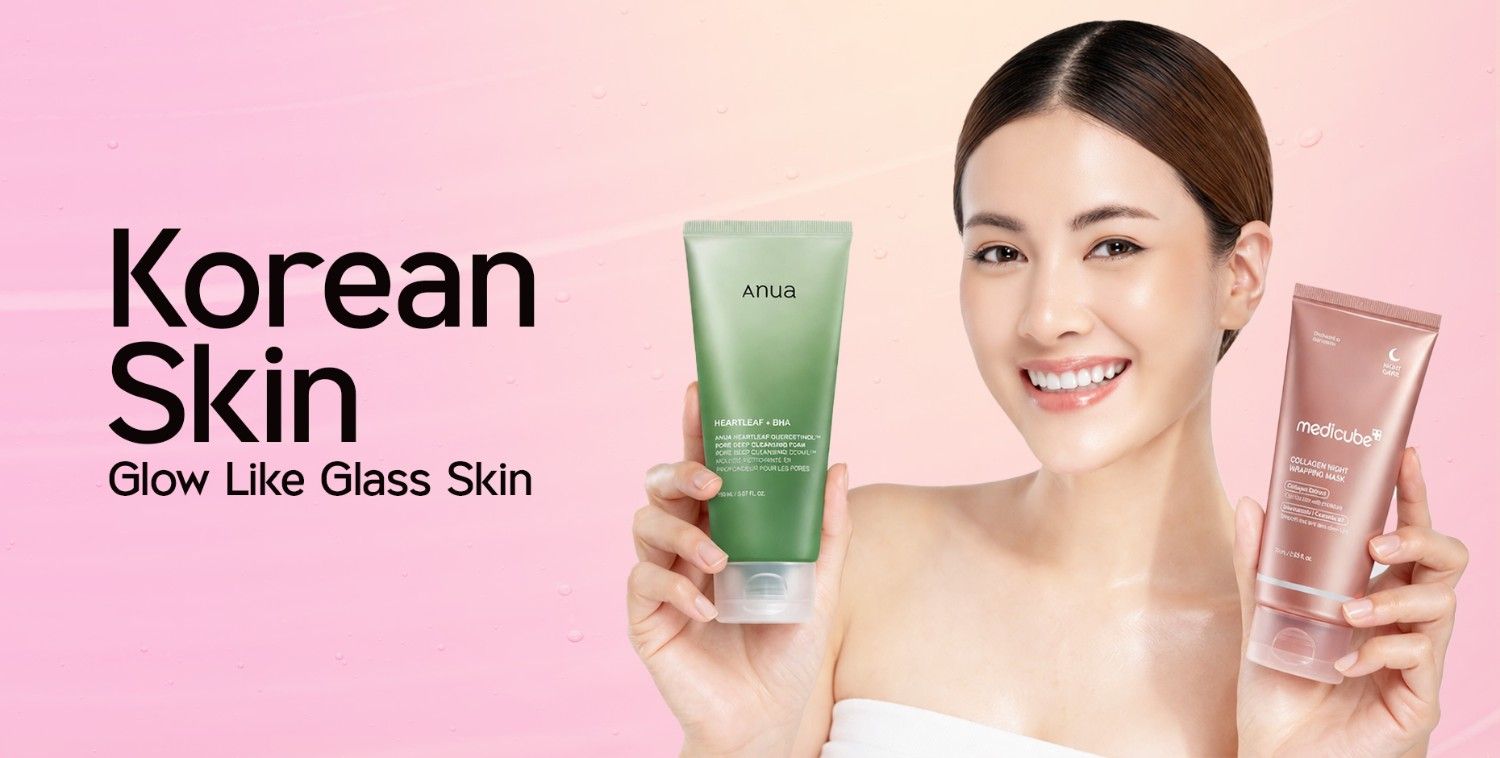 Smiling woman with glowing skin holding green Anua and rose gold Medicube K-beauty products.
