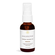 Innersense Harmonic Treatment Oil in a small, amber glass bottle with a white pump dispenser.