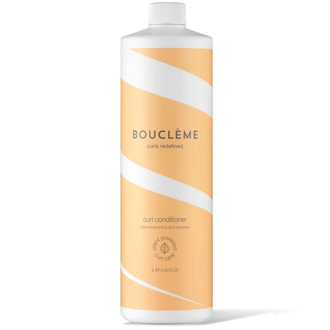White Bouclème Curl Conditioner bottle with orange wavy stripes and white cap, 1L size.