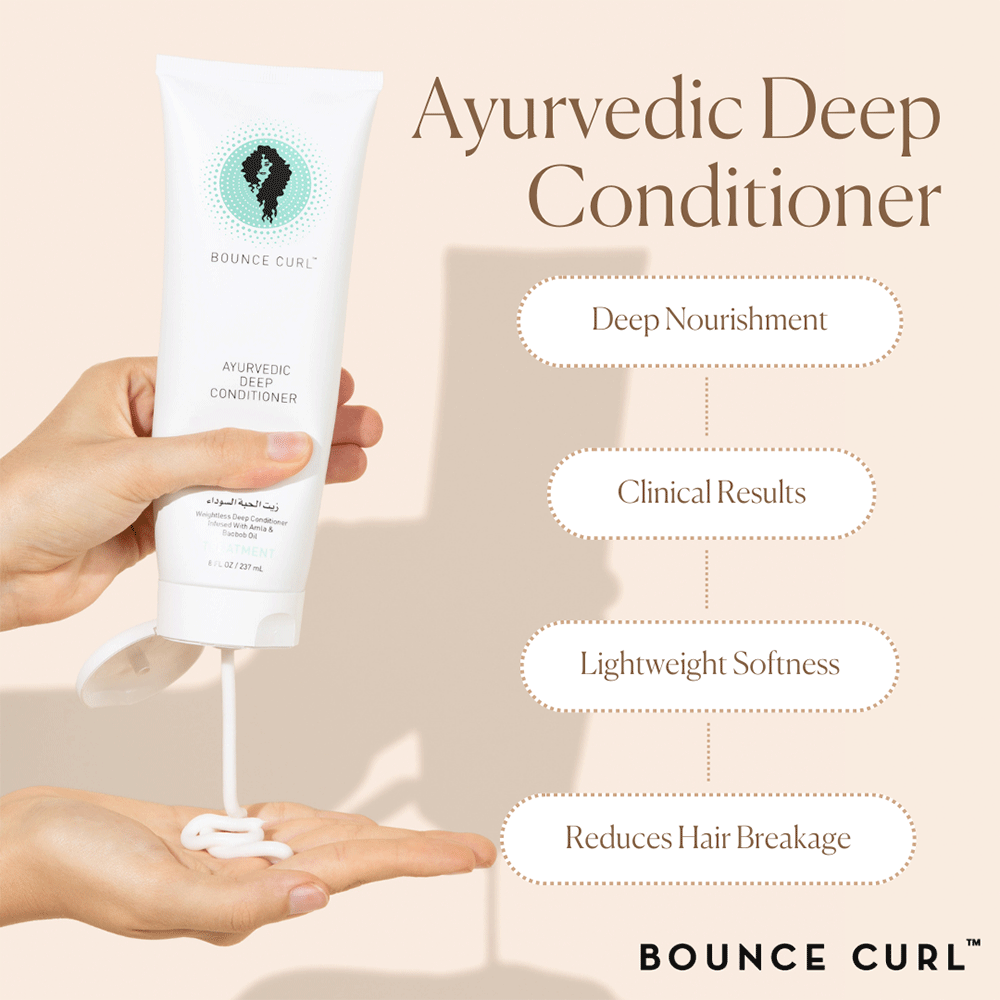 White Bounce Curl Ayurvedic Deep Conditioner tube held by hands, dispensing creamy product onto a palm.