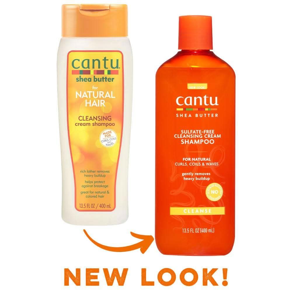 Two Cantu Shea Butter Cleansing Cream Shampoo bottles: old white design on left, new orange design on right.