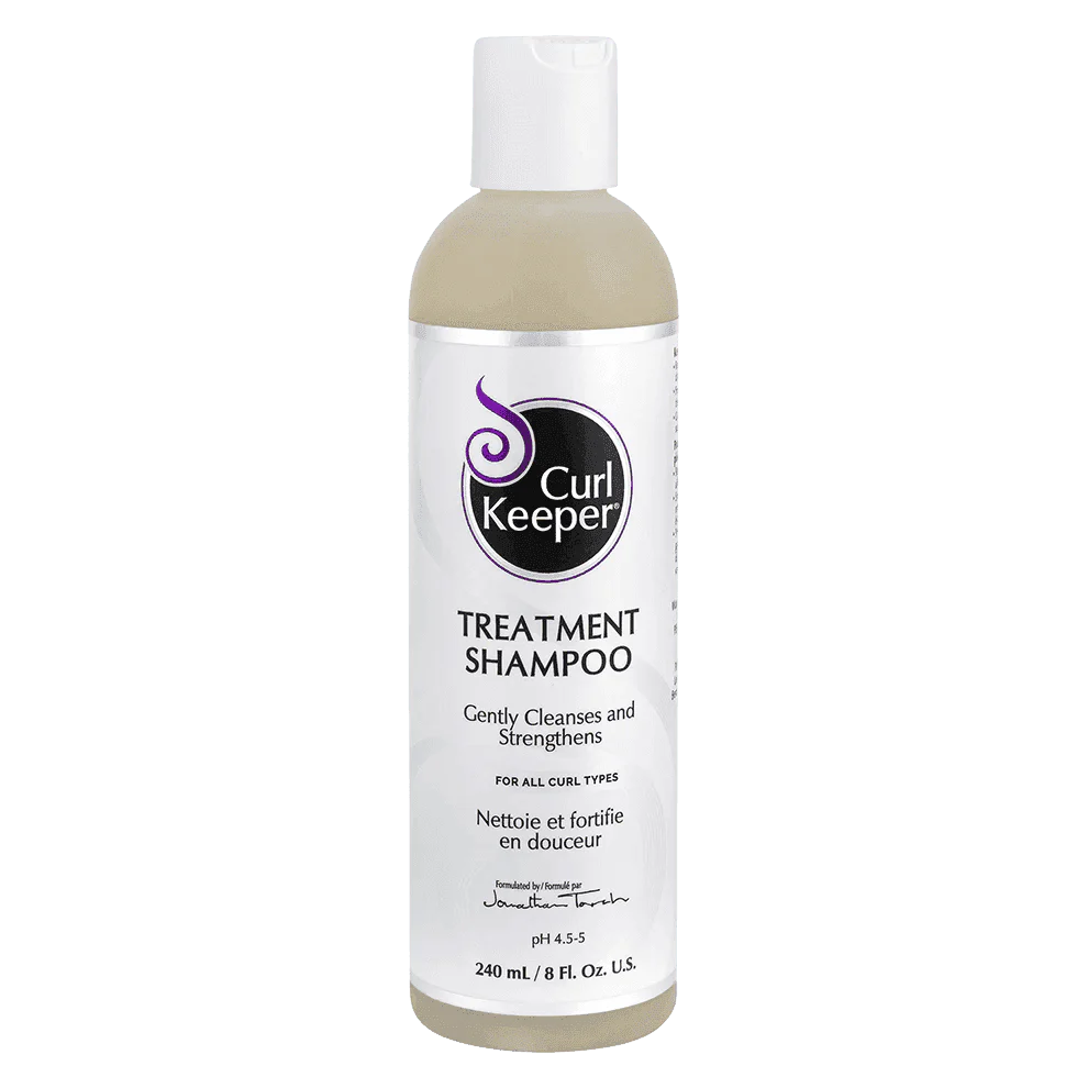 Curl Keeper Treatment Shampoo in a clear 240ml bottle with a white flip-top cap and purple label.