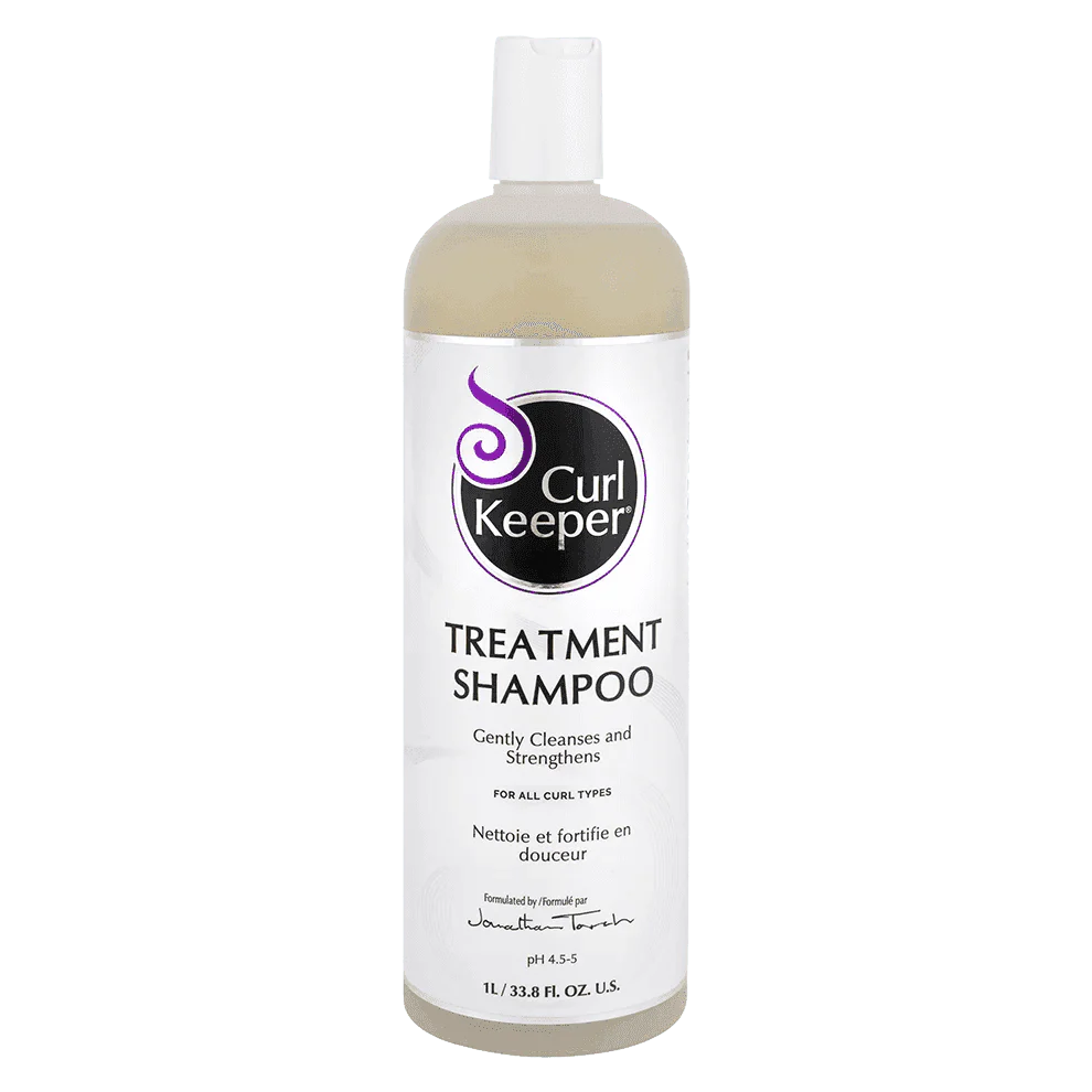 White bottle of Curl Keeper Treatment Shampoo, 1L, with purple logo and text.