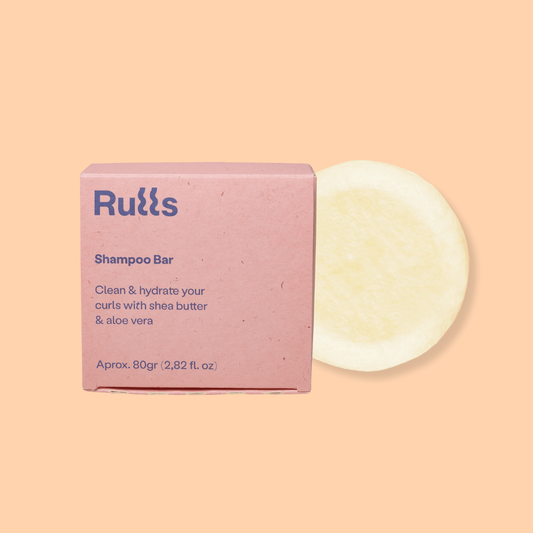 Rulls Solid Shampoo Bar, 80g, in pink paper packaging with a light yellow bar.
