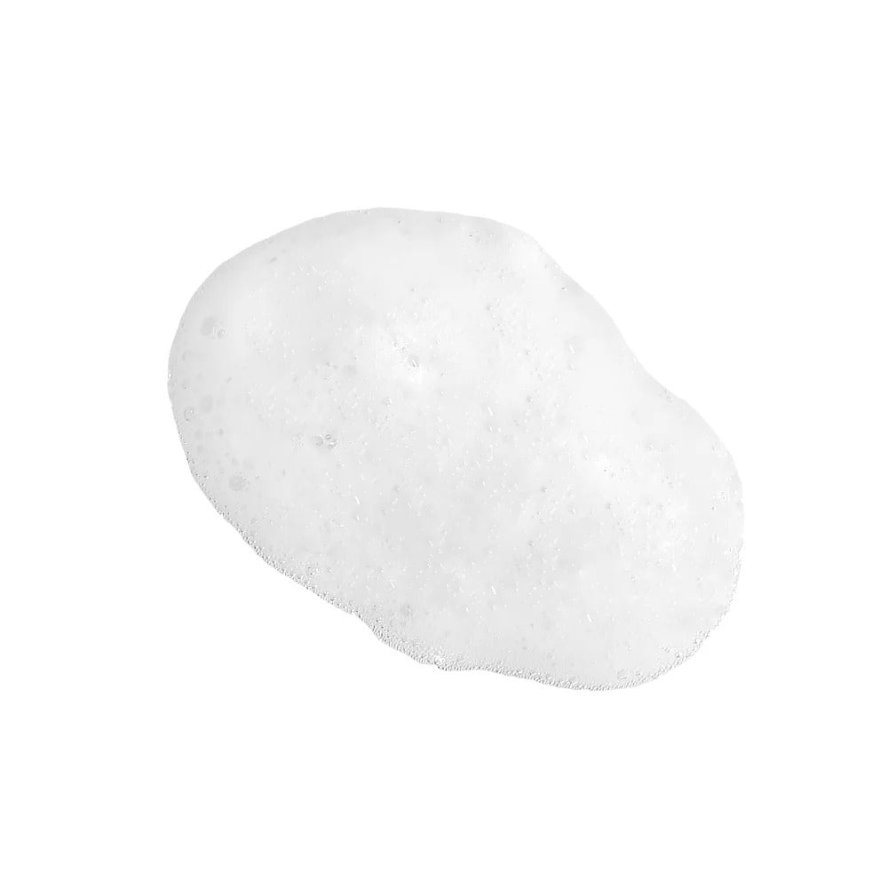 A dollop of white, airy styling foam with small bubbles, isolated on a white background.